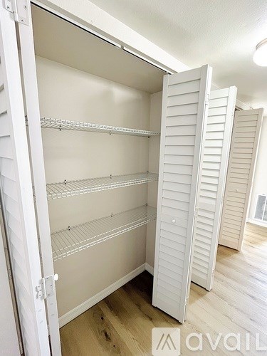 A white closet with shelves and a logo that says "avail".
