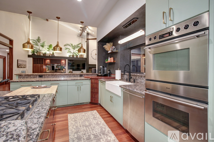 A modern kitchen with a stove top oven and a double oven stove.