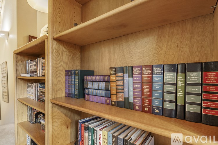 A bookshelf filled with books of various sizes and colors.