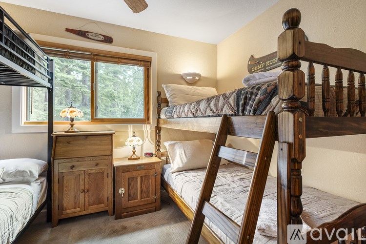 A bedroom with a bunk bed and a twin bed.