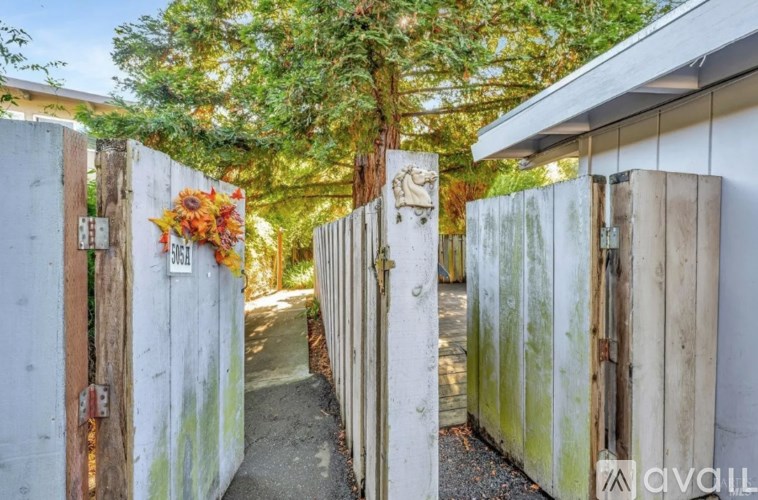 A wooden fence with a sign that says "SOLD" on it.