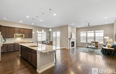 A spacious kitchen with dark wood cabinets and a white island.