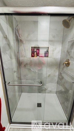 A room with wooden flooring and a window.