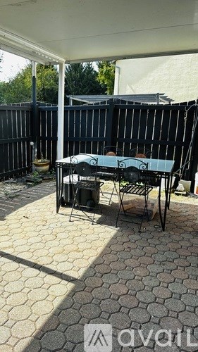 A patio table with chairs is set up on a patio.