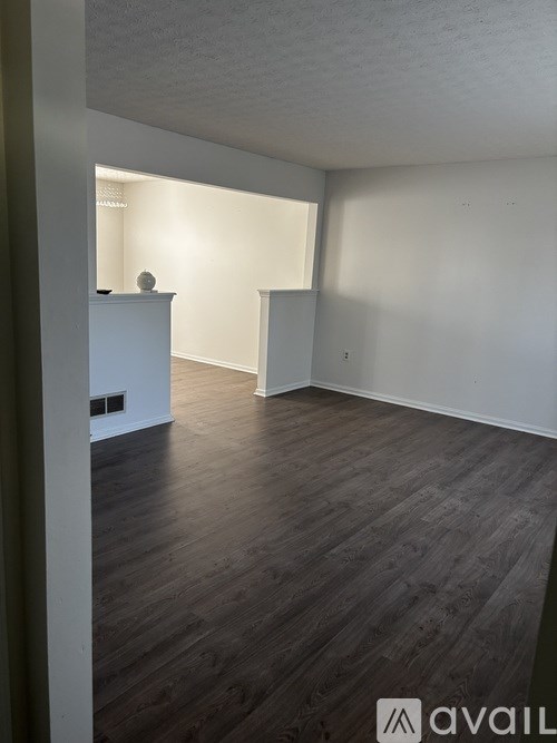A room with wooden floors and white walls.