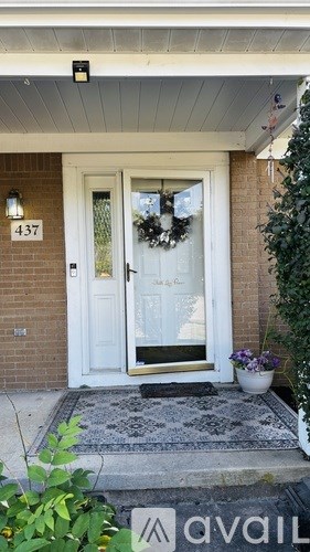 A white door with a glass panel and a wreath on it.