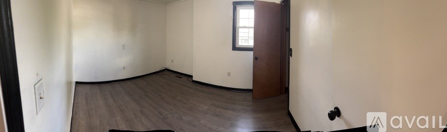 A room with a wooden floor and a door.