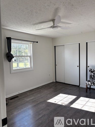 A patio with a table and chairs is covered by a white canopy.