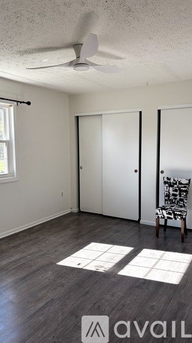A patio with a table and chairs is covered by a white canopy.