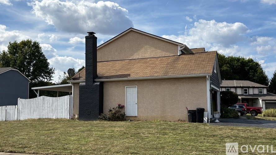 A house with a white fence in front of it.