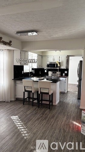 A kitchen with a dining table and chairs.