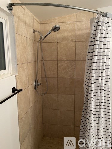 A shower with a curtain and a glass door.