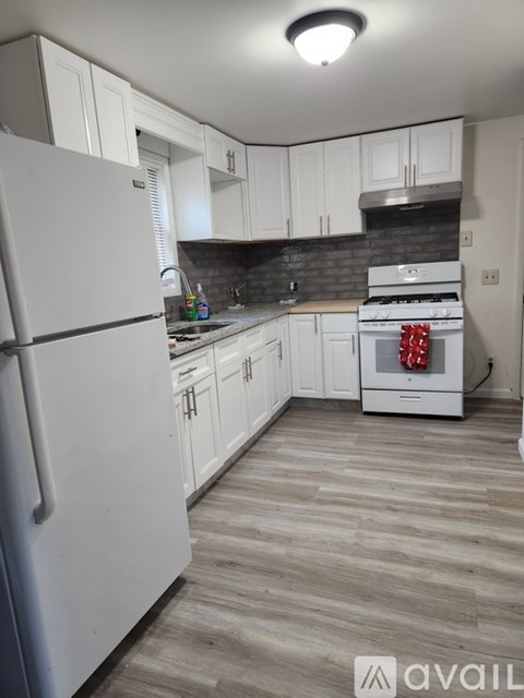 A kitchen with a white fridge and a white oven.