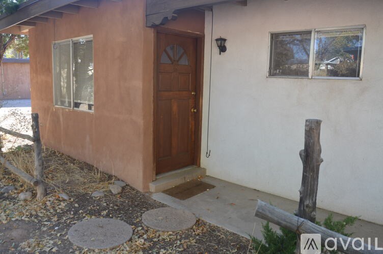 A brown door is on the side of a house.