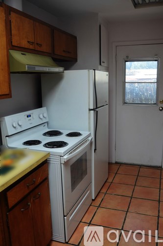 A kitchen with a stove, oven, and refrigerator.