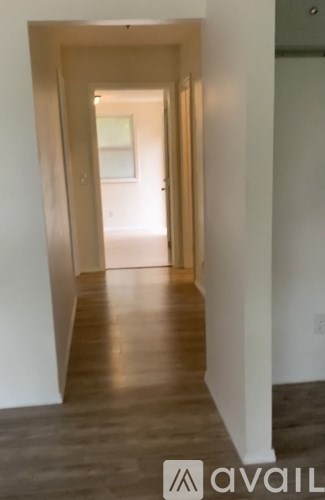 A long hallway with a light at the end.