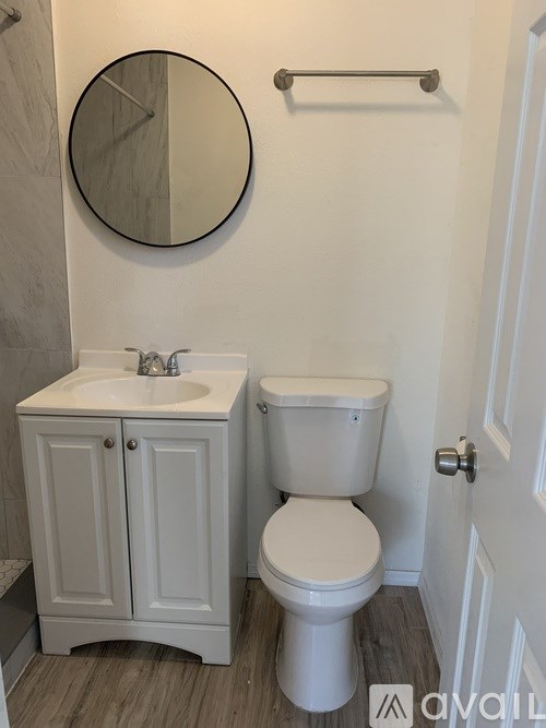 A room with a window and wooden flooring.