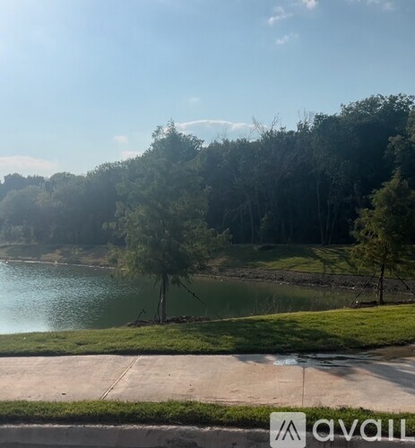 A park with a lake and trees.