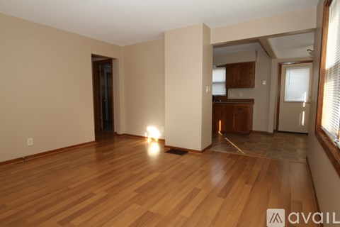 A room with wooden floors and a light on the floor.