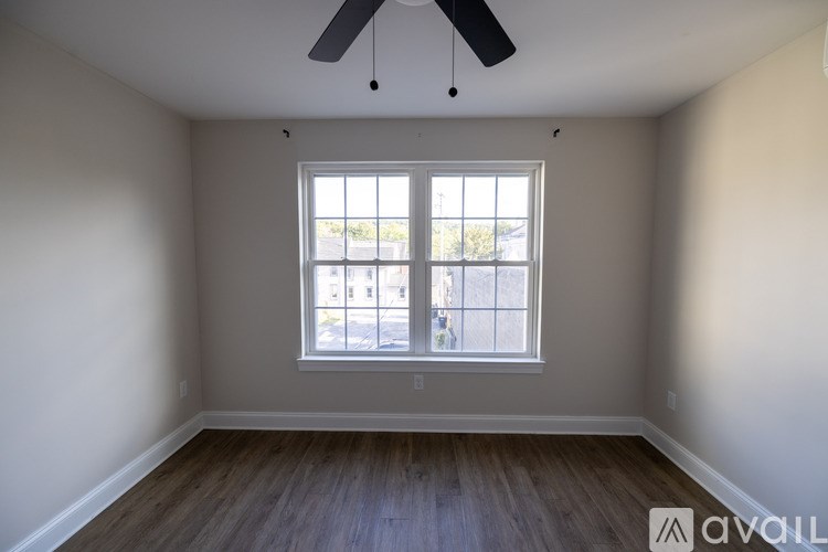 A room with a window and a ceiling fan.