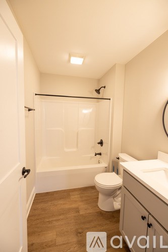 A bathroom with a toilet, sink, and bathtub.