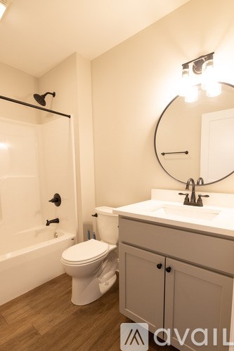 A bathroom with a toilet, sink, and bathtub.