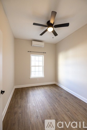 A room with a ceiling fan and a window.