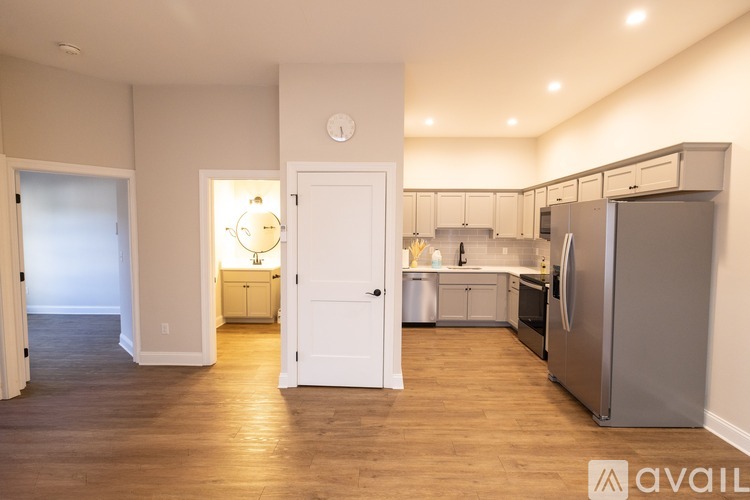 A kitchen with a refrigerator, oven, and cabinets.