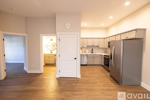 A kitchen with a refrigerator, oven, and cabinets.