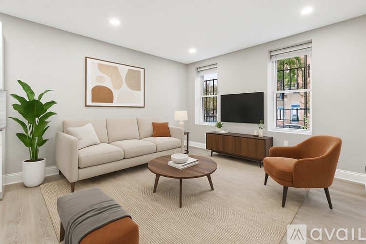 A spacious kitchen with white cabinets and a black door.