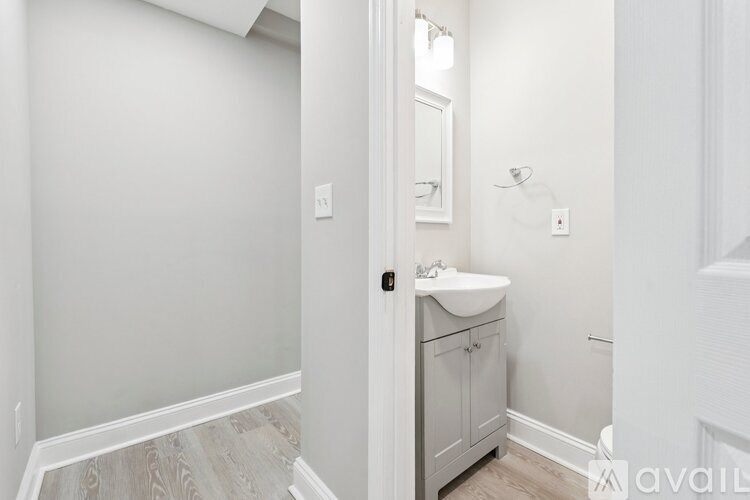 A bathroom with a sink and a cabinet.