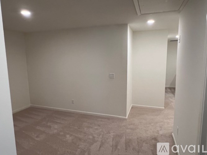 A room with carpeted floor and white walls.