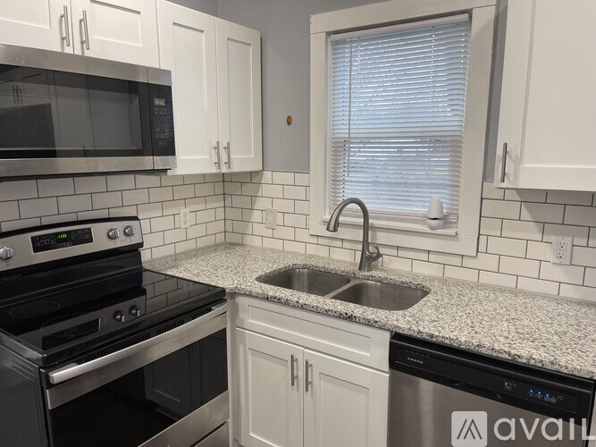 A kitchen with a stove, microwave, and dishwasher.