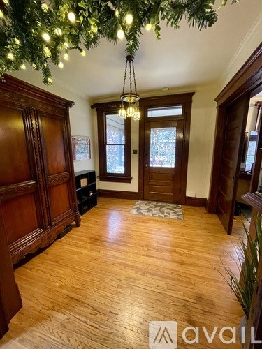 A room with wooden floors and a chandelier.