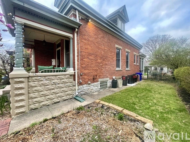 A brick house with a green lawn in front.