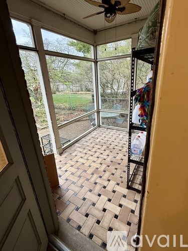 A room with a checkered floor and a ceiling fan.