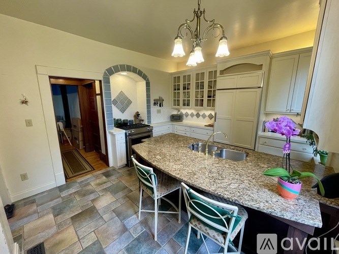 A kitchen with a granite countertop and a sink.