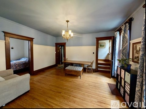 A living room with a grey couch and a wooden floor.