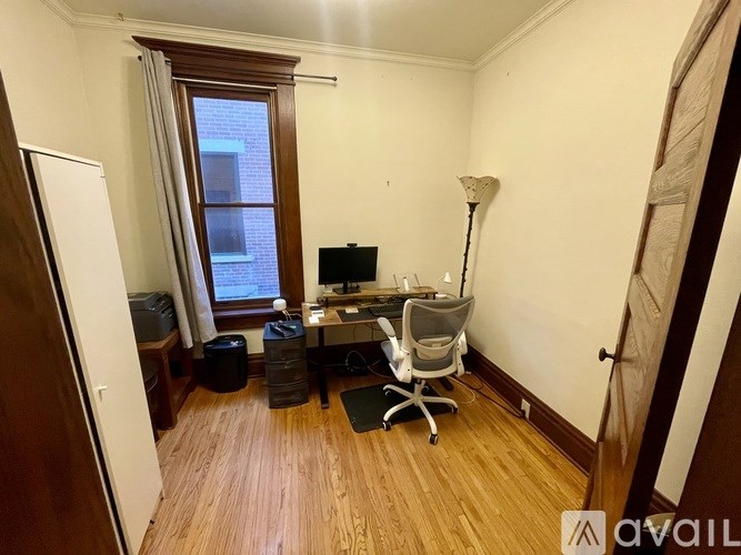 A room with a desk and a chair.
