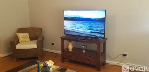 A television is on a stand in a living room.