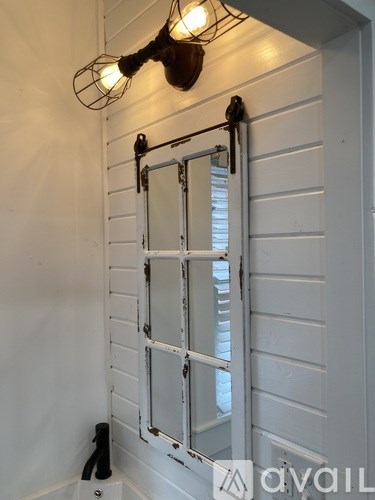 A white door with a window and a light on the top.