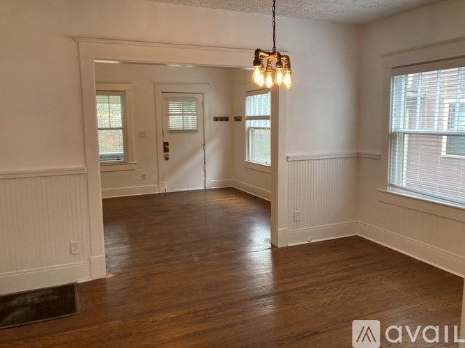 A room with wooden floors and white walls.