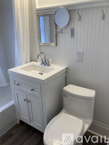 A white toilet sits next to a sink in a bathroom.
