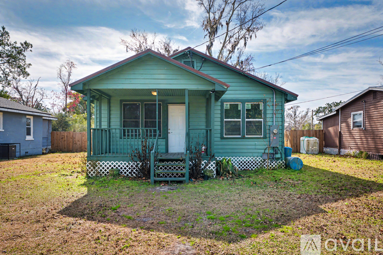 A green house with a dishwasher, washer, and dryer included.