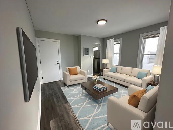 A living room with a large flat screen TV mounted on the wall.