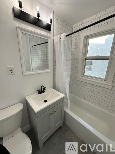 A bathroom with a white sink and a white toilet.