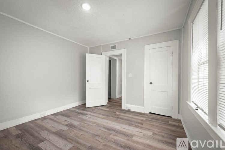 A room with a wooden floor and white walls.