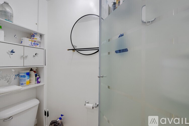 A bathroom with a white tub and a white toilet.