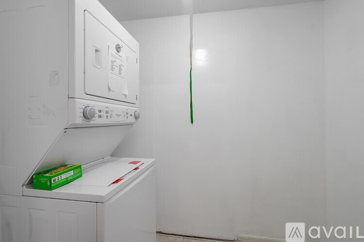 A washing machine with a green box on top of it.