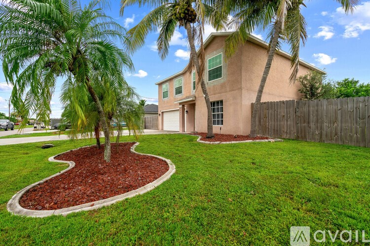 A house with a palm tree in front of it.